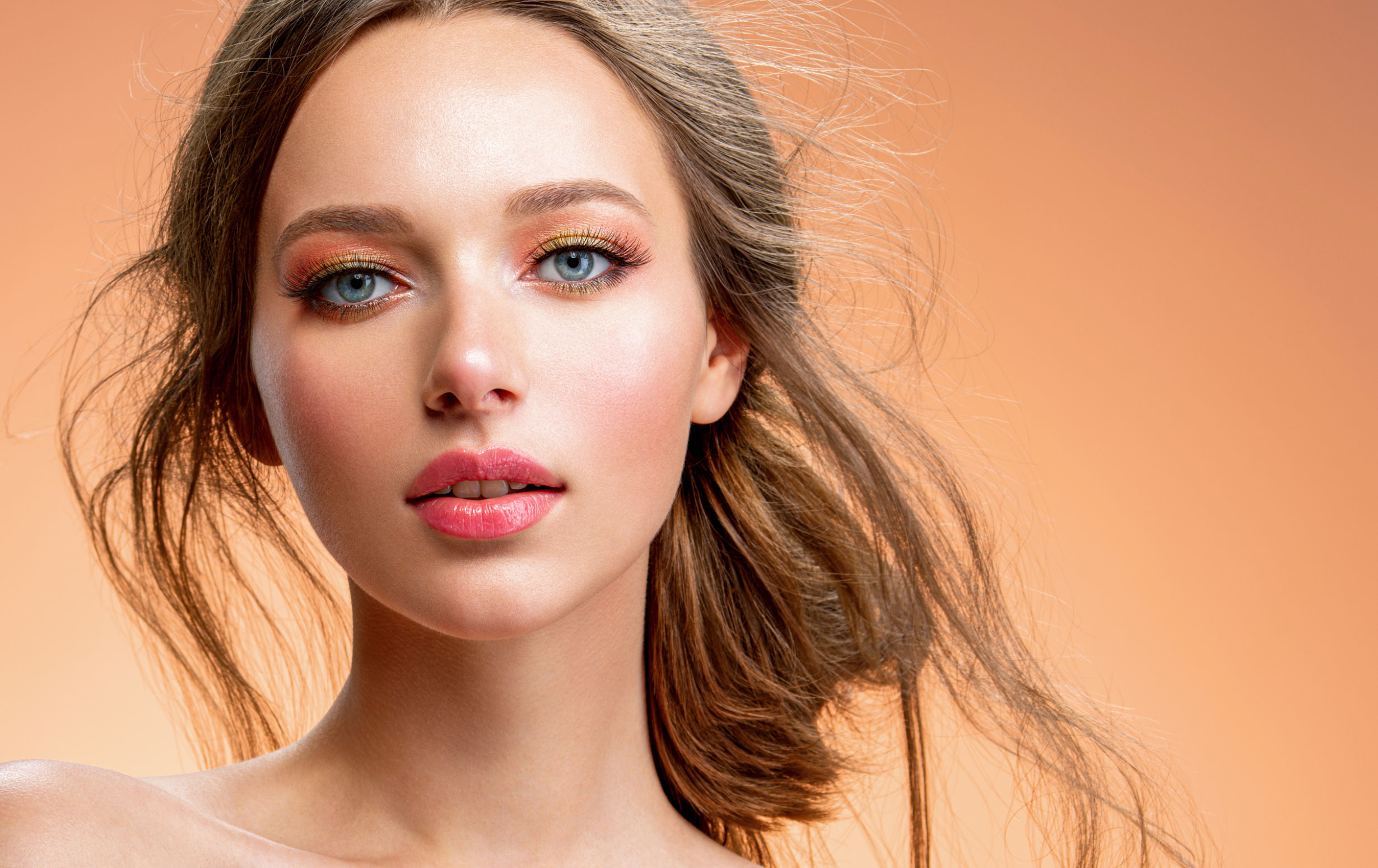 Portrait of a beautiful woman with a long blond hair. Model wit