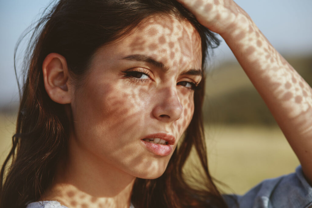 Portrait of a young woman with shadows texture on the face in a